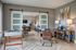 Modern resident lounge featuring a foosball table, reading nook, game table, and a stylish sitting area with sliding barn doors and contemporary decor.