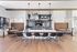 Community kitchen featuring bar seating, booth-style dining nooks, and a modern backsplash with pendant lighting.
