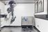 Dog wash station with stainless steel tub, sprayer hose, and dog-themed wall art in a tiled grooming room.