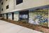 Exterior mural wall at The Grant featuring vibrant floral artwork.
