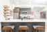 Modern apartment kitchen with dark wood cabinets, stainless steel appliances, a large white island with bar stools, and decorative wall art and bookshelves.