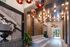 Vibrant lobby entryway with artistic light fixtures, wood-paneled walls, modern seating, and a large mural.