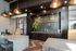 Reception area of Brickline featuring modern decor, sleek stone desks, warm lighting, and a bold gold logo on a dark tiled wall.