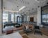 Contemporary lounge with stylish seating, statement lighting, and large windows overlooking the city skyline.