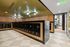 Modern mailroom with black numbered mailboxes, wood-paneled walls, and a green ceiling.