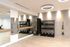 Bright fitness room featuring mirrored walls, a full rack of dumbbells, kettlebells, yoga mats, and open floor space for stretching or functional workouts.