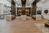 Modern indoor seating area with booth-style benches, warm wood finishes, and overhead lighting, designed for both socializing and focused work.