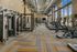 Spacious fitness center featuring treadmills, weight machines, and floor-to-ceiling windows providing plenty of natural light.
