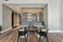 Modern seating area with sleek wooden tables and stylish chairs against a decorative partition.