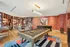 Chic recreational room with a modern billiards table, foosball, and artistic decor.