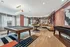 Modern lounge with a stylish pool table, elegant seating, and artistic wall design.