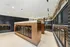 Modern apartment mailbox area with sleek wooden finish and stylish lighting.