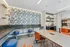 Vibrant meeting area with modern decor, featuring a bold floral wall design and sleek furniture.