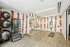 Stylish home gym featuring modern fitness equipment, mirrored wall, and unique orange pattern wallpaper.