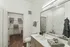 Modern bathroom with elegant fixtures, a spacious vanity, and a sleek shower in a luxury apartment.