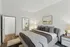 Luxurious bedroom with plush bedding, modern decor, and an ensuite bathroom.