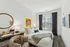 Stylish bedroom with modern decor, featuring a plush bed, artistic wall art, and a large window with views.