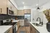 Contemporary kitchen with stainless steel appliances, elegant cabinetry, and a chic black tile backsplash.