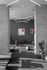 Modern gym interior with sleek lighting, exercise equipment, and abstract art.