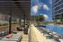 Elegant outdoor pool area with stylish lounge seating and modern architecture.