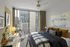 Modern bedroom with stylish decor, large window, and city view.