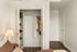 Stylish bedroom with an open closet showing organized storage space and cozy ambiance.