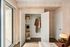 Stylish bedroom with open closet, modern decor, and a serene ambiance.