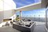 Stunning rooftop terrace with stylish lounge seating, a modern fireplace, and scenic city views.