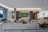 Contemporary living room with gray sectional, innovative fireplace, and artistic decor.
