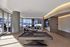 Modern lounge area with a billiards table, cozy seating, and large glass windows overlooking an outdoor terrace.