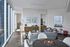 Modern living room with sleek furniture, large windows, and a cozy atmosphere.