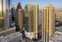 A stunning high-rise building in a bustling downtown area, featuring modern architecture with glass and steel exterior.