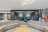 Communal lounge with sleek seating, vibrant artwork, and chic lighting, perfect for relaxing or social gatherings.