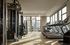 Modern fitness center with state-of-the-art equipment, featuring multiple treadmills and a multi-station gym set, bathed in natural light with cityscape views.
