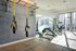 Modern fitness center with TRX equipment and sleek workout machines in a bright, urban setting.