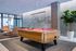 Modern recreational space featuring a sleek billiards table with pink felt, cozy seating area, and stylish contemporary decor.
