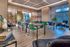 Elegant modern dining area with stylish seating, wooden accents, and abundant natural light, perfect for gatherings.