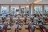 Modern fitness center with sleek cycling machines and mirrored walls, offering a dynamic and energizing workout space.