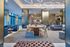 Luxurious apartment lounge featuring elegant modern decor, ambient lighting, and comfortable seating with a sophisticated dining area.