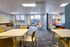 Vibrant children's playroom with colorful furniture, playful wall art, and a cozy seating area offering a welcoming family-friendly space.
