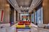 Modern luxury apartment lounge featuring sleek wood paneling, stylish seating, and chic lighting, creating an inviting and sophisticated atmosphere.