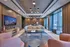 Sophisticated lounge area with modern furniture, soft lighting, and large windows offering a serene ambiance.