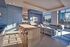 Sleek modern apartment with elegant open living space, large windows showcasing a stunning skyline view, and stylish minimalist furniture.