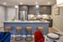 Modern kitchen with sleek cabinetry, stylish pendant lighting, and inviting breakfast bar with seating.