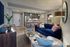 Contemporary open-concept living space with a plush navy sofa, chic kitchen island, and stylish decor accents.