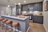 Modern kitchen with stylish cabinetry, stainless steel appliances, and a chic island with seating for four.