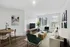 Modern living room with stylish decor, large windows, and cozy seating perfect for relaxation.