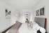 Elegant bedroom with chic wall art and a spacious walk-in closet, featuring a plush bed and modern decor.
