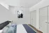 Elegant bedroom with modern decor, featuring a cozy bed, chic artwork, and ample closet space.