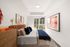 Bright, modern bedroom with chic decor, large windows providing ample natural light, and cozy furnishings for a welcoming atmosphere.